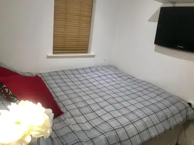 a small bedroom with a bed with a window at 2 Bedroom 2 Double beds Kitchen 2Baths Parking in Bishops Stortford