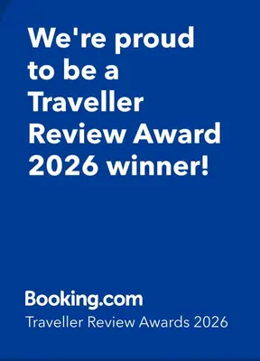 a blue sign that says were proud to be a traveller review award winner at HOME from HOME GUEST HOUSE in Rochford