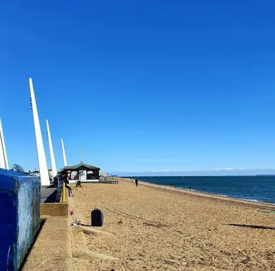 a beach with people on the sand and the water at HOME from HOME GUEST HOUSE in Rochford