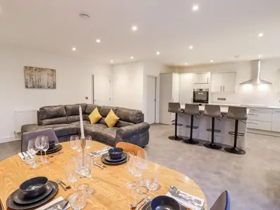 a living room with a table and a couch at Exning Residence in Newmarket