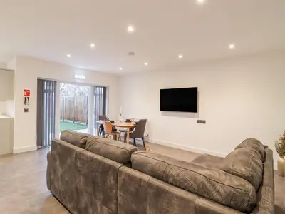 a living room with a couch and a table at Exning Residence in Newmarket