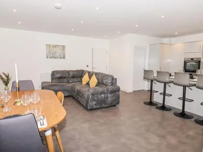 a living room with a couch and a table at Exning Residence in Newmarket