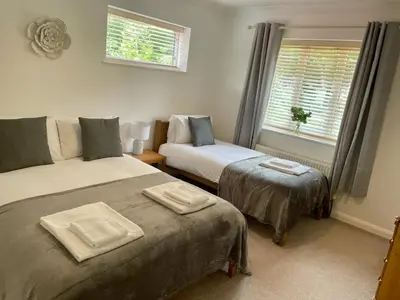 a bedroom with two beds and a window at Number 15 in Norwich