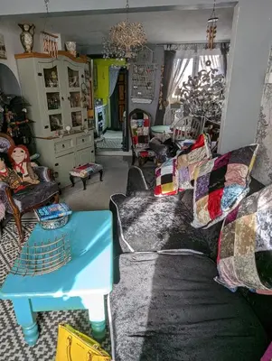 a living room with a couch and a table at Quaint & Quirky House Colchester Town Centre in Colchester