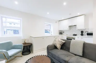 a living room with a couch and a kitchen at Budget 1 Bedroom Apartment in Central Ipswich in Ipswich