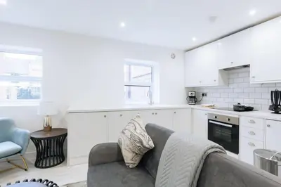 a living room with a couch and a kitchen at Budget 1 Bedroom Apartment in Central Ipswich in Ipswich