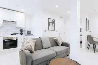 a living room with a couch and a kitchen at Budget 1 Bedroom Apartment in Central Ipswich in Ipswich