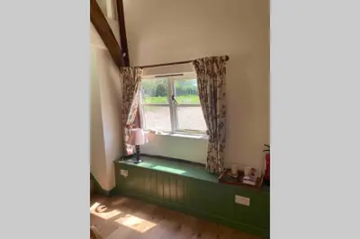a room with a window with a green window sill at Gorgeous comfortable barn with huge private orchard in quiet Suffolk location in Depden