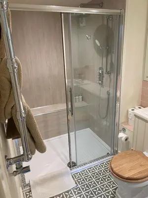 a shower stall in a bathroom with a toilet at Gorgeous comfortable barn with huge private orchard in quiet Suffolk location in Depden