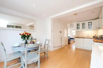 a kitchen and living room with a table and chairs at 201 High Street in Aldeburgh