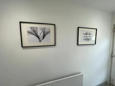 two framed pictures on a white wall at ED Colchester Accommodation with Garden View in Colchester