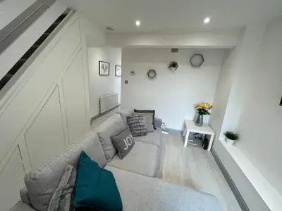 a living room with a couch and a table at ED Colchester Accommodation with Garden View in Colchester