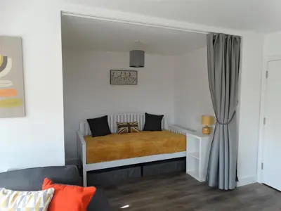 a bedroom with a bed in a white room at Old Station Apartments in Cambridge