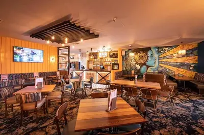 a restaurant with tables and chairs in a room at St Osyth- Sleeps8-freeparking-wifi-holidaypark in Clacton-on-Sea