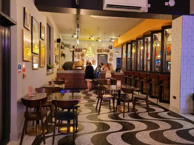a restaurant with tables and chairs and people in the background at St Osyth- Sleeps8-freeparking-wifi-holidaypark in Clacton-on-Sea