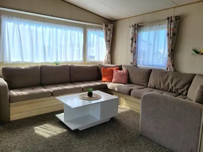a living room with a couch and a table at St Osyth- Sleeps8-freeparking-wifi-holidaypark in Clacton-on-Sea