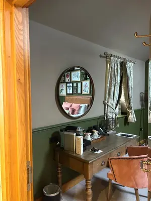 a room with a table and a mirror at Guinness Arms in Icklingham
