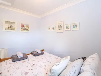 a bedroom with a bed with two towels on it at Hunters Lodge in Norwich