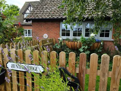 a wooden fence in front of a house at Hunters Lodge in Norwich