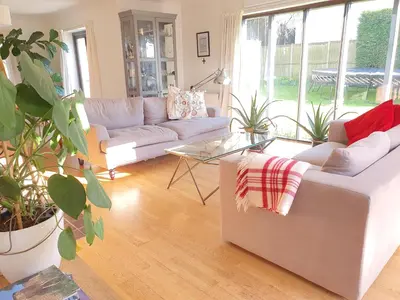a living room with couches and potted plants at Island Retreat with HotTub in West Mersea