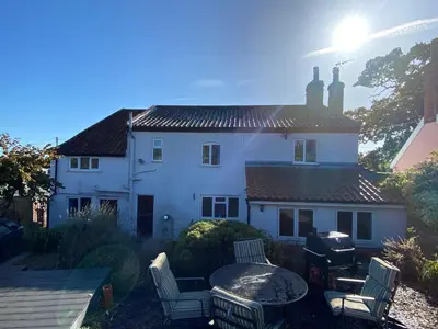 a white house with a table and chairs at Carlton Cottage Country Retreat - Perfect for Ipswich - Aldeburgh - Southwold - Thorpeness - Sizewell B - Sizewell C - Sleeps 13 in Little Glenham