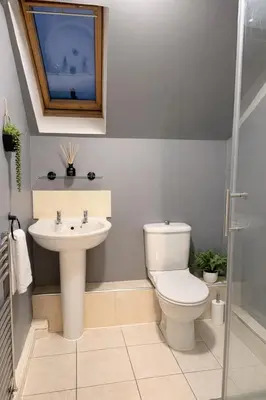 a bathroom with a toilet and a sink at Modern Spacious Flat In Ipswich - Sleeps 6 - Parking in Freston