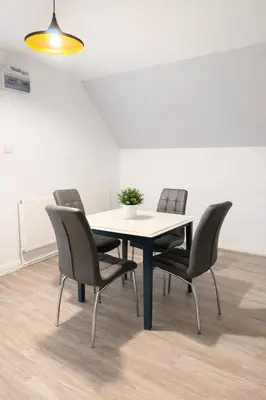 a table with four chairs and a potted plant on it at Modern Spacious Flat In Ipswich - Sleeps 6 - Parking in Freston