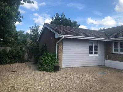 a house with a white garage at The Annexe II in Mildenhall