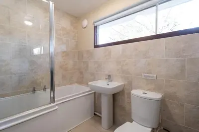 a bathroom with a toilet and a sink and a shower at Sea Poppies in Thorpeness