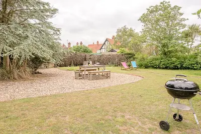 a grill in a yard with a picnic table at Sea Poppies in Thorpeness