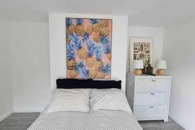 a bedroom with a bed and a painting on the wall at The Bungalow in Chesterton