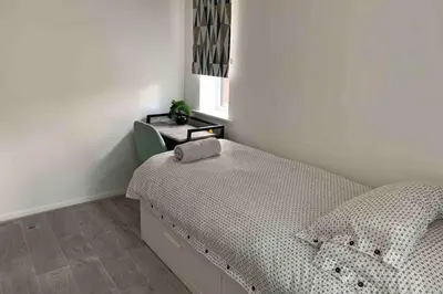 a bedroom with a bed and a desk in it at The Bungalow in Chesterton