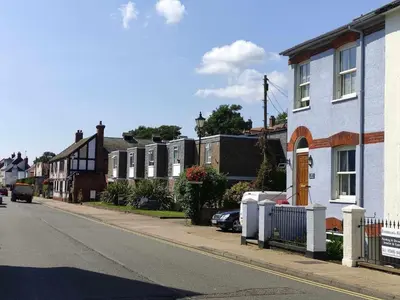 a street with a row of houses on a city street at Settled In, Aldeburgh in Aldeburgh