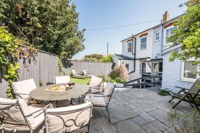 a patio with a table and chairs at Settled In, Aldeburgh in Aldeburgh