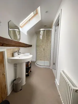 a bathroom with a sink and a shower at Immaculate barn annexe close to Stansted Airport in Great Dunmow