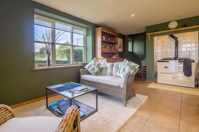 a living room with a couch and a table at The Granary, Dunstall Green in Denham