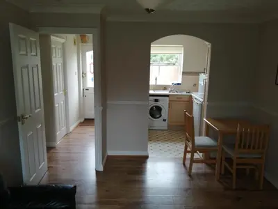 a kitchen and dining room with a table and a table and chairs at Grant Close in Wickford