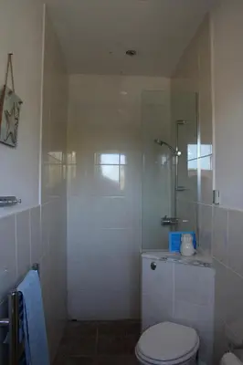 a bathroom with a shower with a toilet and a sink at Cherry Trees in Stowmarket