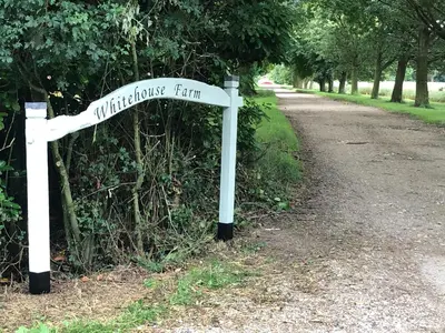 a white street sign sitting on the side of a road at Cherry Trees in Stowmarket