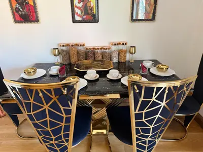 a dining room with a black table and chairs at Barnfields Retreat in Little Clacton