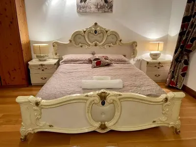 a large white bed in a bedroom with two night stands at Barnfields Retreat in Little Clacton
