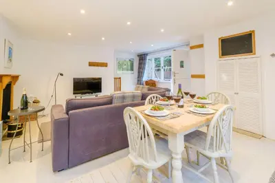 a living room with a table and a couch at Theberton Cottage in Theberton