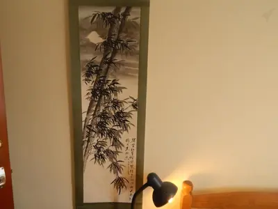 a picture of a plant on a wall with a lamp at Science Park Suite in Cambridge