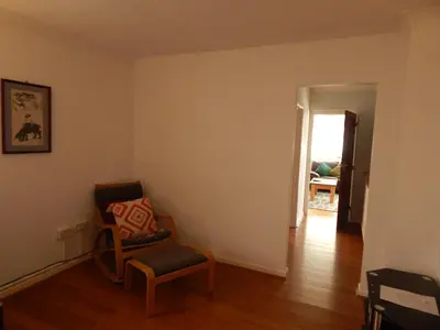 a living room with a chair and a door at Science Park Suite in Cambridge