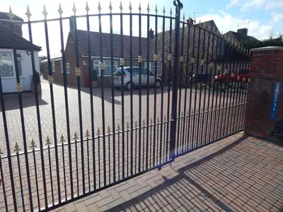 a metal fence with a car parked behind it at Science Park Suite in Cambridge