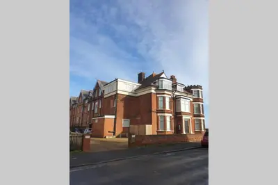 a large brick house on a city street at 2 Bedroom Seafront Apartment in Felixstowe