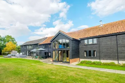 an exterior view of a house with a yard at Old Hall Barn - Aldeburgh Coastal Cottages in Darsham
