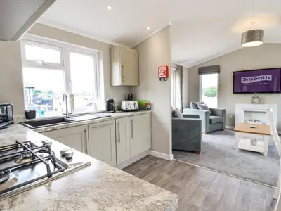 a kitchen and living room with a couch and a table at Lodge 47 in Ipswich