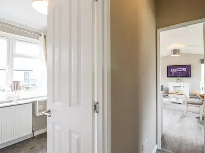 a door leading to a living room with a window at Lodge 47 in Ipswich