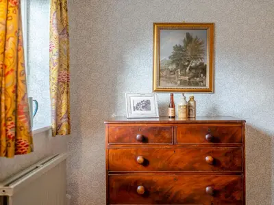 a dresser in a room with a picture on the wall at Little Crown in Winfarthing